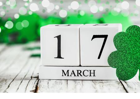 Happy St Patrick's day. White wood calendar blocks with the date March 17th. Selective focus with blurred background. - Stock Image
